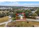 Aerial view of a home and well manicured lawn, surrounded by mature trees in a desirable neighborhood at 10339 Castillo Ct, Clermont, FL 34711