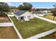 Aerial view of a fenced backyard with a covered outdoor kitchen and firepit area at 10339 Castillo Ct, Clermont, FL 34711