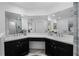 Elegant bathroom with dual vanities, ample counter space, and a well-lit mirror at 10339 Castillo Ct, Clermont, FL 34711