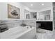 Luxurious bathroom with a soaking tub, dual vanities, and stylish tile work at 10339 Castillo Ct, Clermont, FL 34711