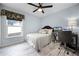 Comfortable bedroom with a bed, desk, and ample natural light at 10339 Castillo Ct, Clermont, FL 34711