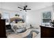Sun-filled bedroom featuring neutral tones, a large bed, and a view of the outdoors at 10339 Castillo Ct, Clermont, FL 34711