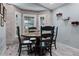 Cozy dining area with stone accent wall, three windows for natural light and stylish decor at 10339 Castillo Ct, Clermont, FL 34711