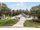 An aerial view of the front of this home on a well manicured lot with mature trees at 10339 Castillo Ct, Clermont, FL 34711