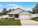 Charming single-story home with a two-car garage, well-maintained lawn and an attractive neutral exterior paint scheme at 10339 Castillo Ct, Clermont, FL 34711