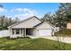 Attractive single-story home with a two-car garage, well-maintained lawn, and an attractive neutral exterior at 10339 Castillo Ct, Clermont, FL 34711