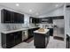 Modern kitchen featuring stainless steel appliances, a center island, and sleek, dark cabinetry at 10339 Castillo Ct, Clermont, FL 34711