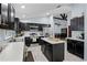 Modern kitchen with stainless steel appliances, center island, and ample cabinet space with view to dining room at 10339 Castillo Ct, Clermont, FL 34711
