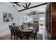 Open-concept living room with dining area, fireplace, and high ceilings with exposed beams at 10339 Castillo Ct, Clermont, FL 34711
