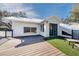 Rear exterior showcasing large deck, partial synthetic lawn, and white stucco exterior for outdoor living at 11036 Schooner Way, Windermere, FL 34786