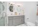 Modern bathroom boasts double vanity, stylish fixtures, updated lighting, and elegant shower at 11036 Schooner Way, Windermere, FL 34786