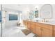 Bright bathroom featuring double vanities, modern fixtures, a walk-in shower, and stylish lighting at 11036 Schooner Way, Windermere, FL 34786