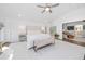 Serene main bedroom boasts an open layout, plush bedding, a seating area, and leads into a living space at 11036 Schooner Way, Windermere, FL 34786