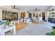 Covered patio features ceiling fans, travertine flooring, and outdoor seating areas for entertaining at 11036 Schooner Way, Windermere, FL 34786