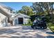 View of detached garage showing brick-paved parking and a golf cart stored nearby at 11036 Schooner Way, Windermere, FL 34786
