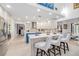 Open kitchen with island, bar seating, and stainless steel appliances overlooking living spaces at 11036 Schooner Way, Windermere, FL 34786