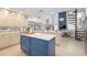 Spacious open-concept kitchen featuring a blue island, ample counter space, and a view of the living area at 11036 Schooner Way, Windermere, FL 34786