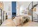 Bright living room with a spiral staircase, high ceilings, stylish decor, and seamless flow to other areas at 11036 Schooner Way, Windermere, FL 34786
