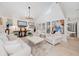 Bright living room featuring high ceilings, neutral furniture, and a view of the pool area at 11036 Schooner Way, Windermere, FL 34786