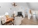 Inviting living room featuring high ceilings, a large TV, stylish decor, and seamless flow into adjacent bedroom at 11036 Schooner Way, Windermere, FL 34786