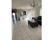 Living room with tile floors, sofas, and a view of the kitchen at 12131 Calaboose Ct, Orlando, FL 32828