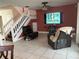 Spacious living room featuring a large TV and comfortable seating at 12131 Calaboose Ct, Orlando, FL 32828