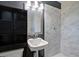 Updated bathroom with marble shower and dark vanity at 1246 Margina Ave, Daytona Beach, FL 32114