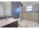 Updated bathroom with dark vanity and grey tile at 1246 Margina Ave, Daytona Beach, FL 32114