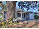 Home with screened porch and large oak tree in the front yard at 1246 Margina Ave, Daytona Beach, FL 32114