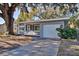 Charming ranch home with screened porch, large oak tree, and spacious driveway at 1246 Margina Ave, Daytona Beach, FL 32114