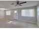 Bright living room with neutral walls, ceiling fan, and carpet at 1246 Margina Ave, Daytona Beach, FL 32114