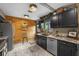 Modern kitchen features granite countertops, stainless steel appliances, and a wood accent wall at 1424 Cavendish Rd, Winter Park, FL 32789