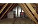 View of an unfinished attic with storage boxes and wooden beams at 1517 Lancashire Way, Deland, FL 32720