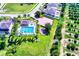 Community pool and playground with surrounding homes and landscape at 15318 Harvest Blvd, Clermont, FL 34714