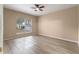 Bright bedroom with wood-look flooring and large window at 15318 Harvest Blvd, Clermont, FL 34714