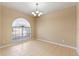 Bright dining room with tile floors and an arched window at 15318 Harvest Blvd, Clermont, FL 34714