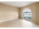 Bright dining room with tile floors and an arched window at 15318 Harvest Blvd, Clermont, FL 34714