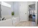 Bathroom with soaking tub and access to the main bedroom at 15503 Amberbeam Blvd, Winter Garden, FL 34787