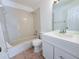 Clean bathroom with a white vanity, shower/tub combo, and tile at 1627 Eagle Creek Cir # 36, Orlando, FL 32807