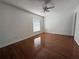 Bright bedroom with wood-look flooring and window blinds at 1627 Eagle Creek Cir # 36, Orlando, FL 32807