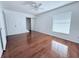 Spacious bedroom featuring wood-look floors and a ceiling fan at 1627 Eagle Creek Cir # 36, Orlando, FL 32807
