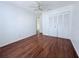 Bedroom with wood flooring, ceiling fan, and double door closet at 1627 Eagle Creek Cir # 36, Orlando, FL 32807