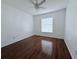 Bright bedroom with wood-look flooring and window blinds at 1627 Eagle Creek Cir # 36, Orlando, FL 32807