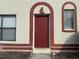 Home's exterior features a red door and arched entryway at 1627 Eagle Creek Cir # 36, Orlando, FL 32807