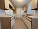 Bright kitchen features white appliances and ample cabinetry at 1627 Eagle Creek Cir # 36, Orlando, FL 32807