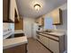 Bright kitchen features white appliances and ample cabinetry at 1627 Eagle Creek Cir # 36, Orlando, FL 32807