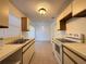 Bright kitchen features white appliances and ample cabinetry at 1627 Eagle Creek Cir # 36, Orlando, FL 32807