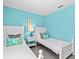 Bedroom with two twin beds, light blue walls, and matching decor at 164 Sevilla Ave, Davenport, FL 33897