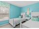 Bedroom with two twin beds, light blue walls, and matching decor at 164 Sevilla Ave, Davenport, FL 33897