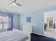 Light blue bedroom with white dresser and a view of another room at 164 Sevilla Ave, Davenport, FL 33897